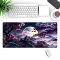 Large black 400x900mm desk pad with patterned surface for keyboard and mouse on a wooden desk.