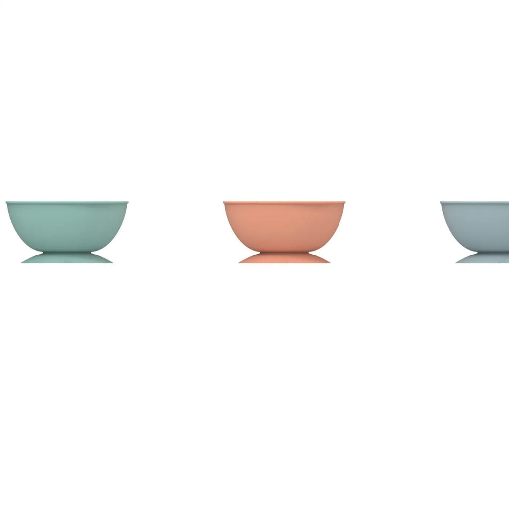 Cyan silicone slow feeding bowl for pets with suction cup base on a flat surface.
