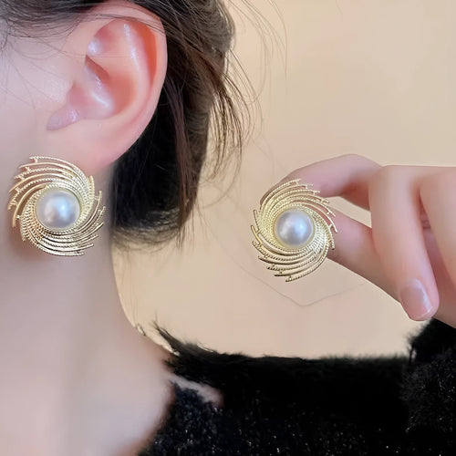 A pair of vintage floral-shaped alloy earrings with a single pearl centre and electroplated finish.