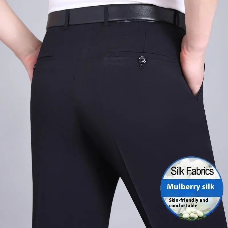 Man wearing dark blue straight-leg suit trousers with a high waist, made from a mulberry silk blend fabric.