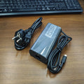 Black 65W Type-C laptop power adapter with a set of interchangeable international plug heads.
