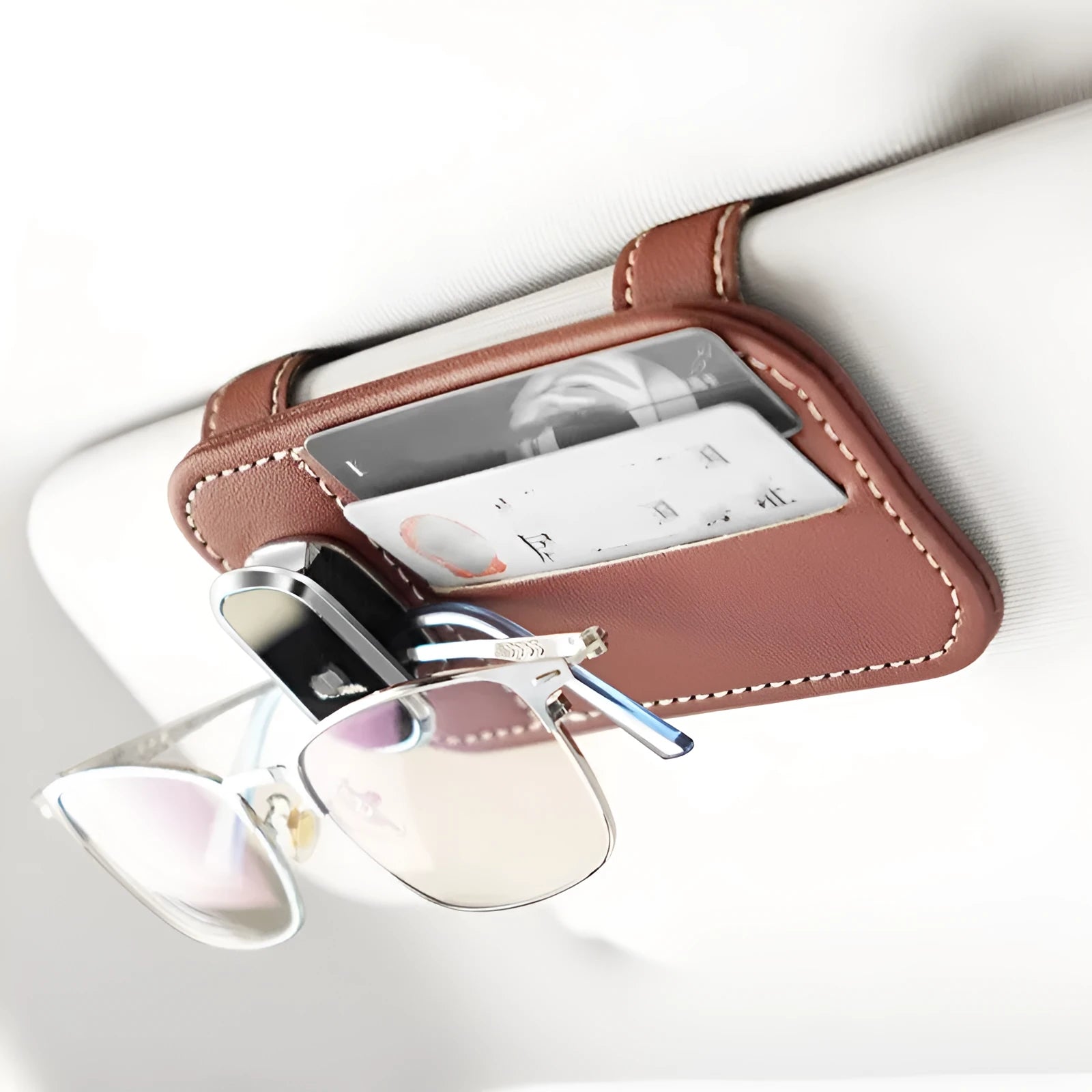 Cowhide leather card holder clipped onto a car sun visor in a choice of colours.