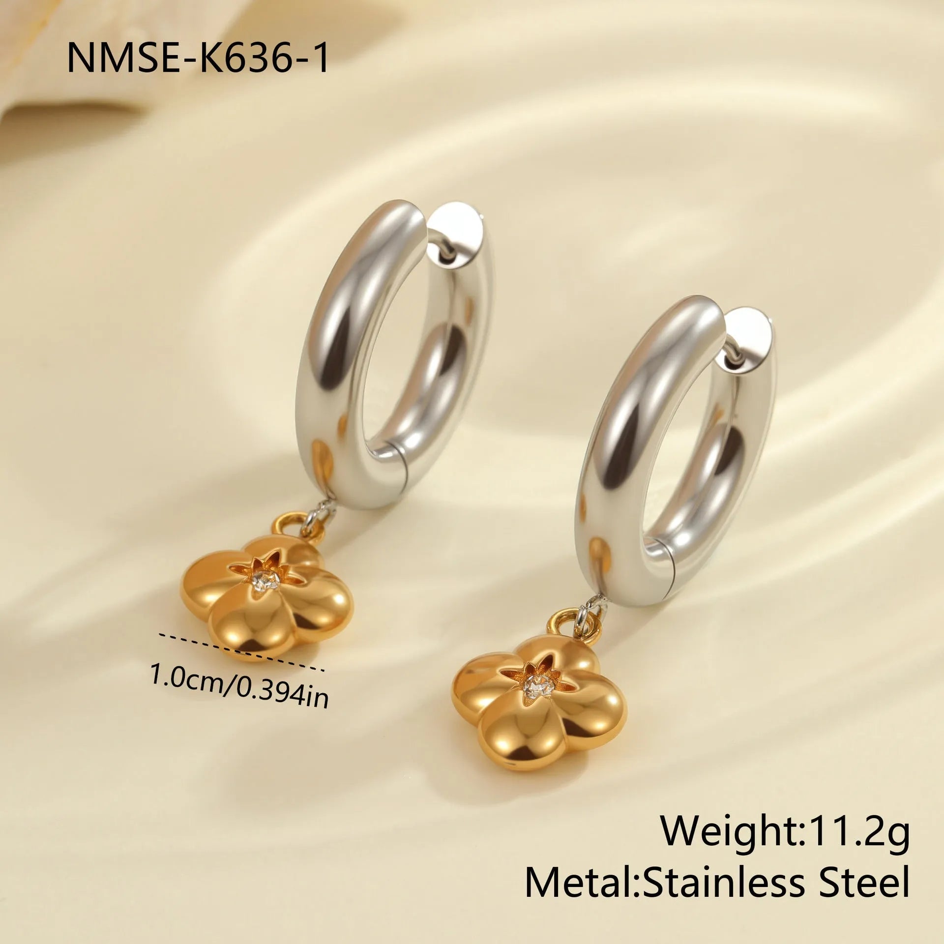 A pair of stainless steel earrings with an 18K gold colour finish, shown in a Christmas tree shape and a heart shape.
