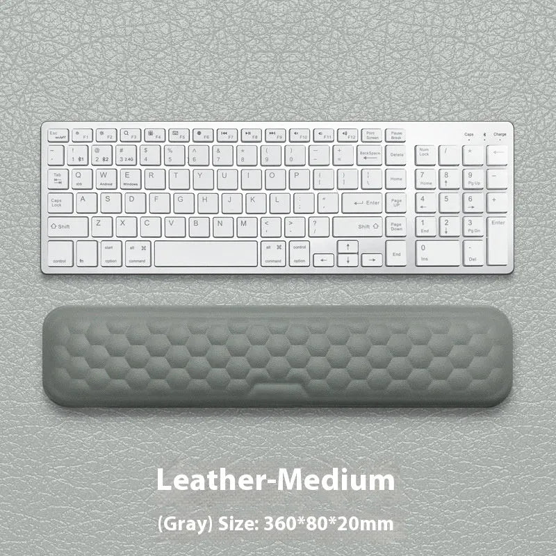 Customisable memory foam mouse wrist pad with black cloth cover on a desk.