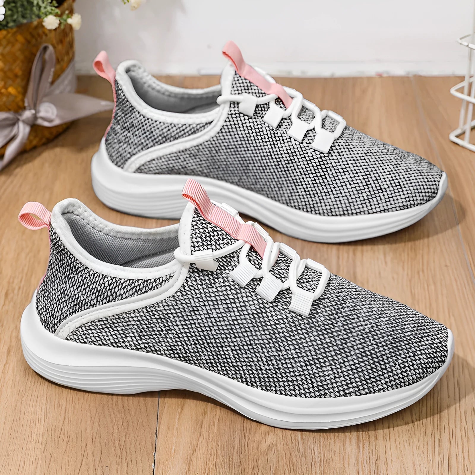 Women's low-top black mesh casual sneakers with lace-up front and round toe on a white background.