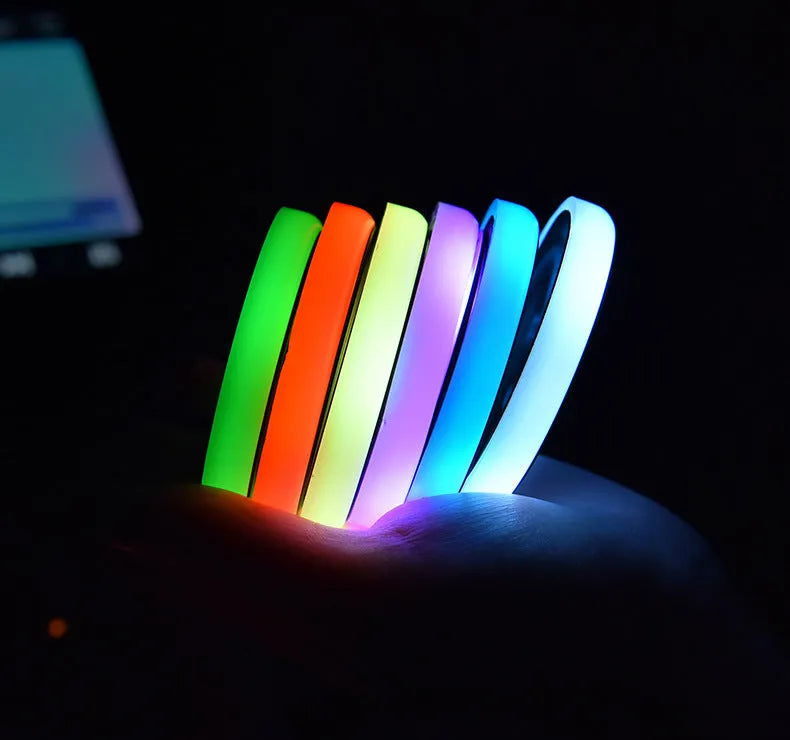 Colourful LED light-up coaster for car cup holder showing seven light colours and USB cable.