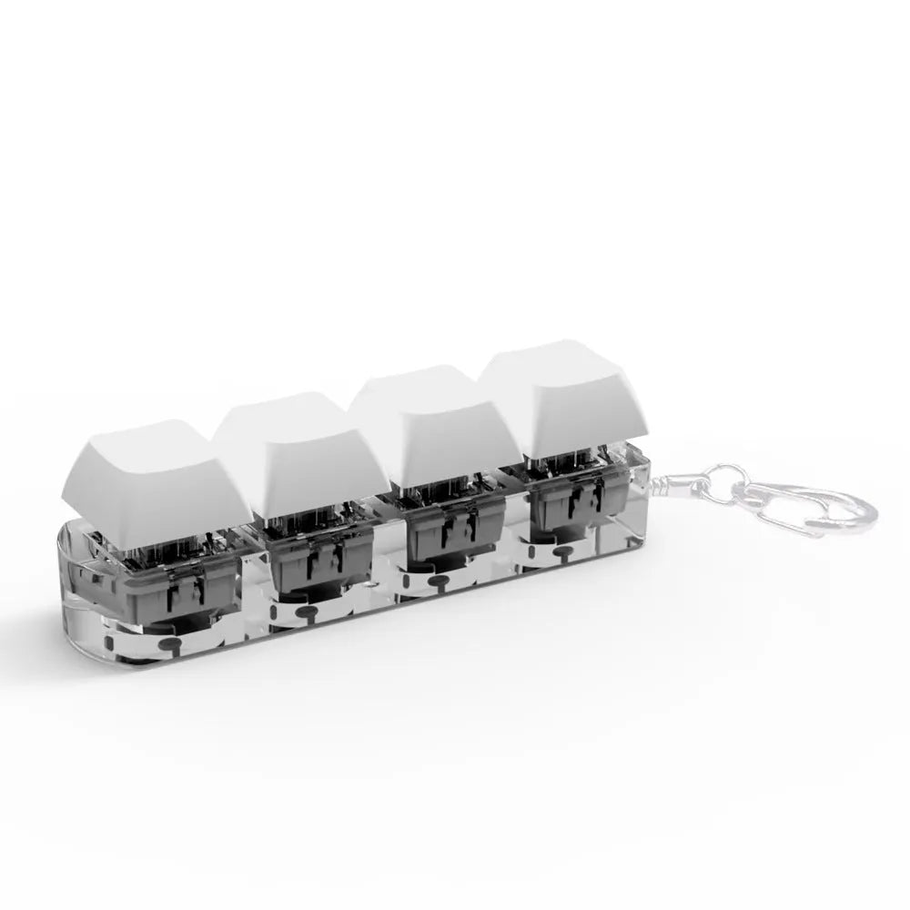 Four-key mechanical keyboard switch tester made of ABS plastic on a desk.
