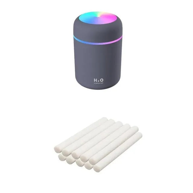 Pink USB portable humidifier with 300ml water tank on wooden desk surface