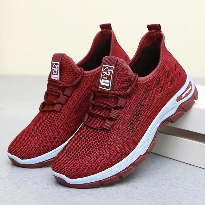 Men's and women's casual low-top sneakers with a soft PVC sole in black, red, light purple, grey, and brown.