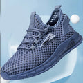 Men's beige casual sneaker with synthetic leather upper, mesh lining, and lace-up front.