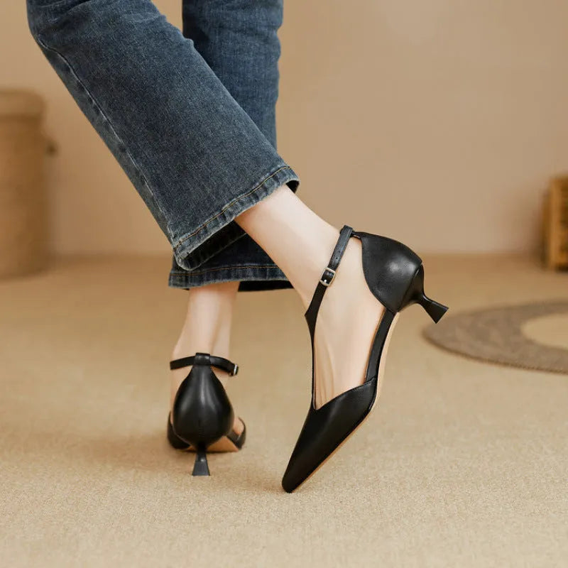 Women's black pointed toe high heels made from cowhide leather.