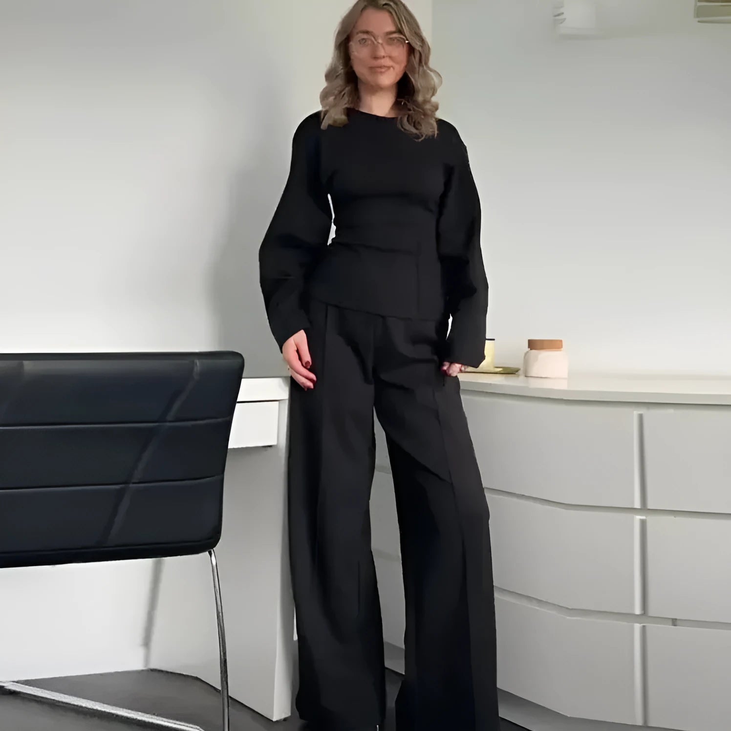 Women's apricot polar fleece suit set with long sleeve top and wide leg trousers on a hanger.