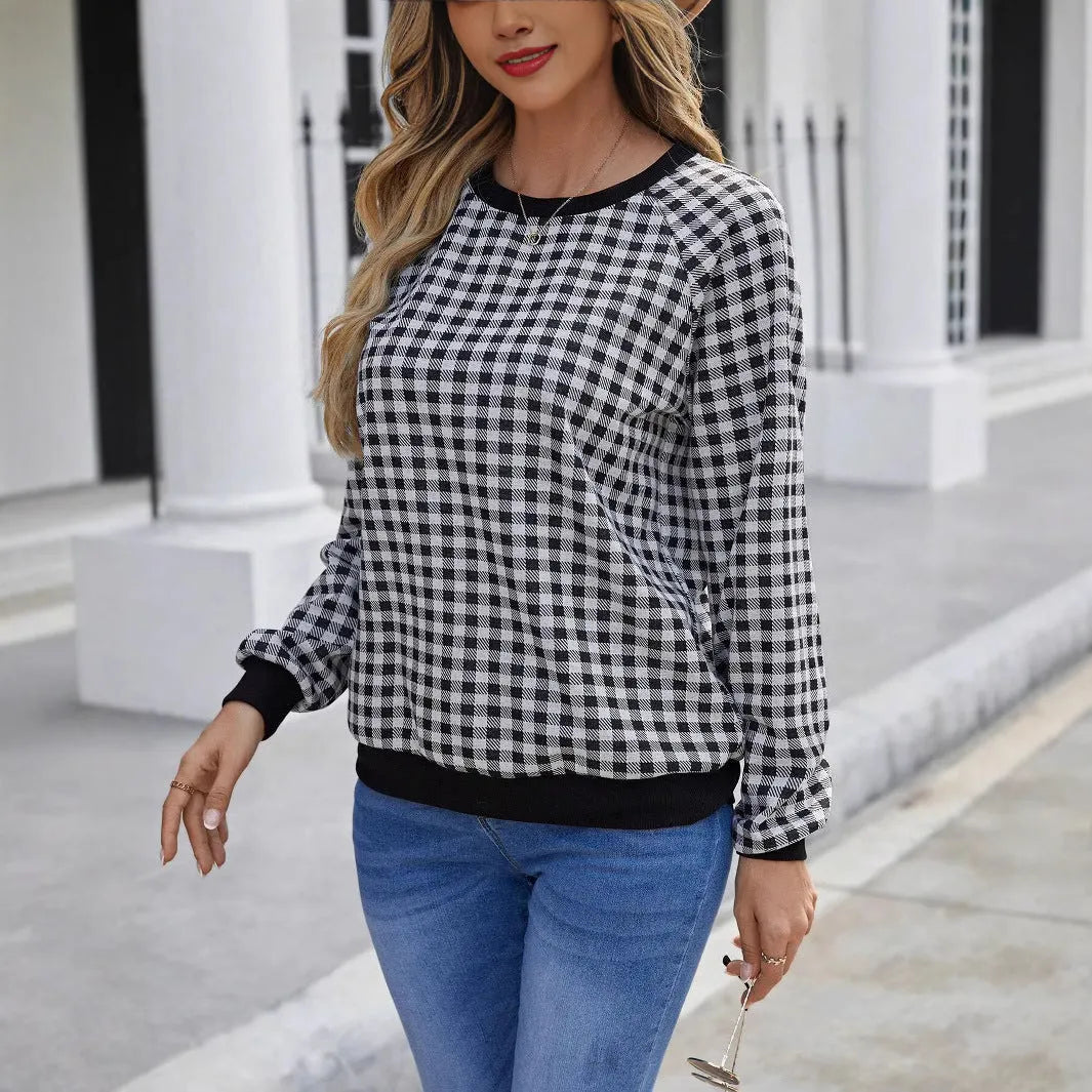 Black long sleeve pullover sweater with a striped plaid pattern and printed design detail.
