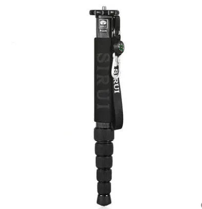 Black carbon fibre telescopic camera monopod extended to full height on a grey background.