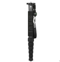Black carbon fibre telescopic camera monopod extended to full height on a grey background.