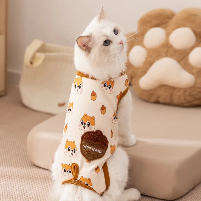Small dog wearing Chip 'n' Dale themed cream onesie with yellow trim and embroidered acorn pocket