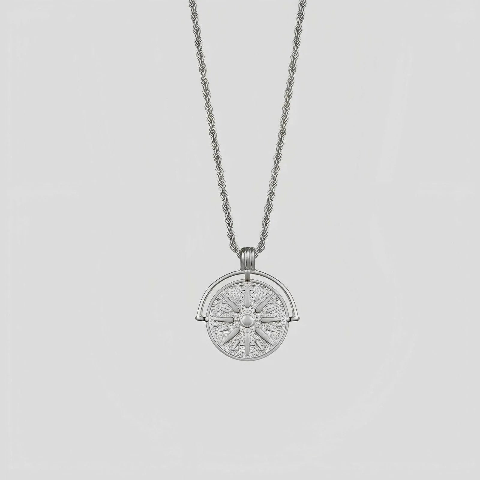 Round stainless steel pendant necklace with sunflower embossing and geometric design on adjustable hemp flowers chain