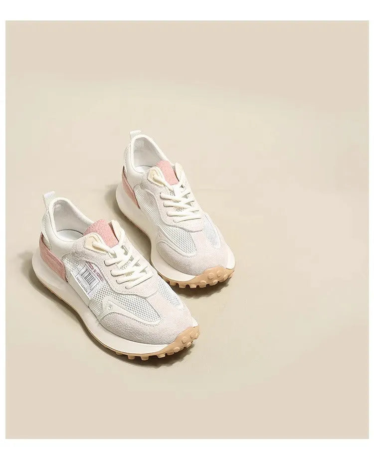 Grey and pink women's low-top retro sneakers with round toe and shallow mouth on a rubber sole.