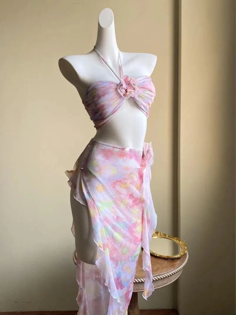 Women's floral split skirt-style swimsuit bikini three-piece set in pink with top, skirt, and panties