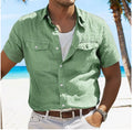 Man wearing a loose-fitting grey cotton cardigan-style shirt with long sleeves.