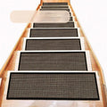 Japanese-style linen-look stair mat in camel colour on a wooden step, showing rubber bottom.
