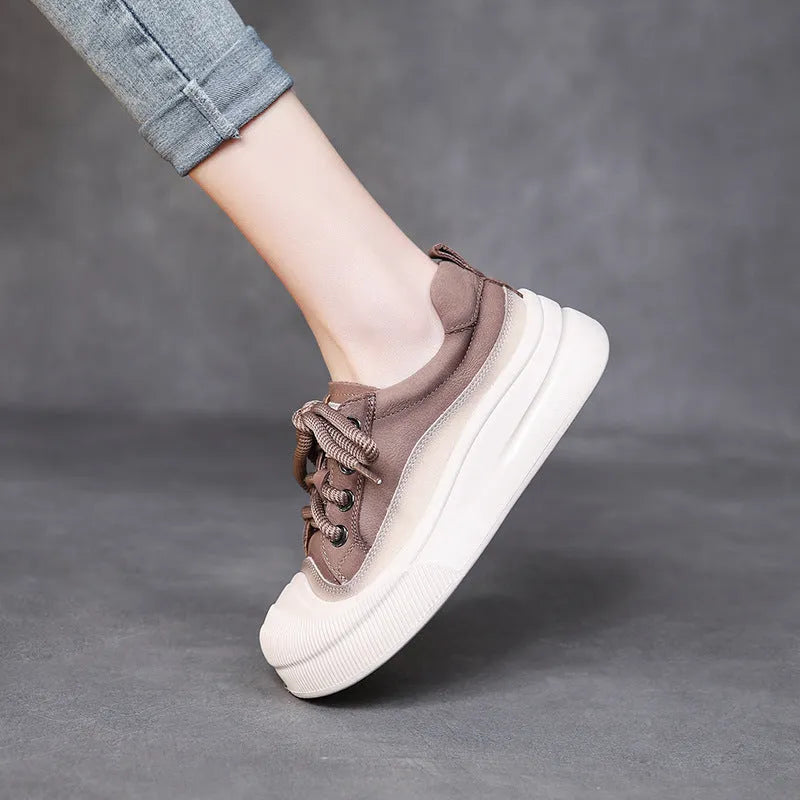 Women's yellow lace-up casual leather shoes with round toe and rubber sole on a neutral background.