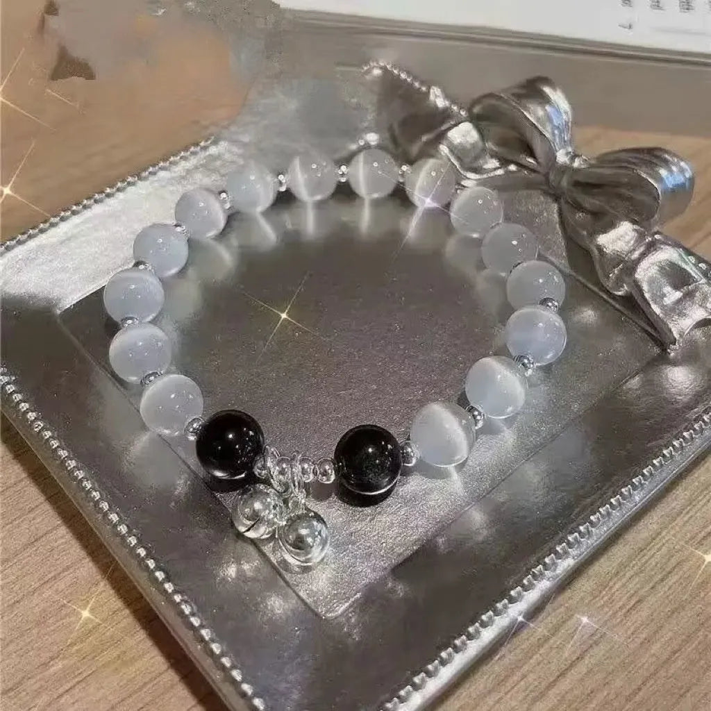 Women's glass butterfly drop-shape bracelet in a grey colourway with round details.