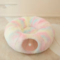 Closed cat tunnel nest 95cm made of long fluffy plush in rainbow colour on a wooden floor