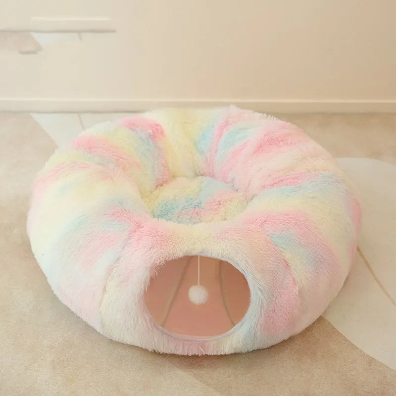 Closed cat tunnel nest 95cm made of long fluffy plush in rainbow colour on a wooden floor