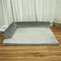 Corduroy pet sofa bed with bolster sides in a grey colour, shown on a wooden floor.