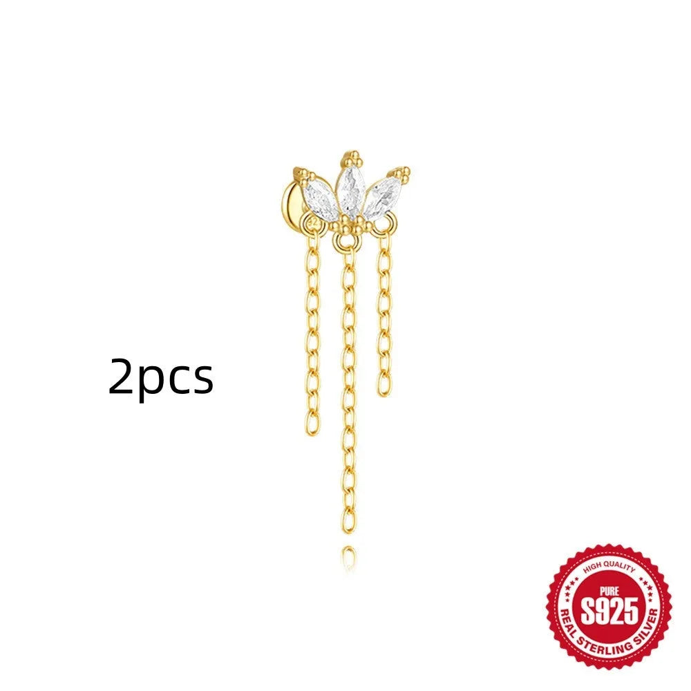 Geometric kite-shaped sterling silver earring with rhinestone head and gold chain tassel.