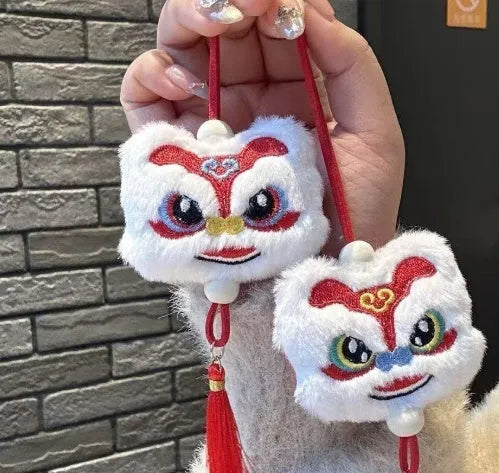 Blue and yellow handmade plush lion keychain ornaments with star stone decoration on white background.