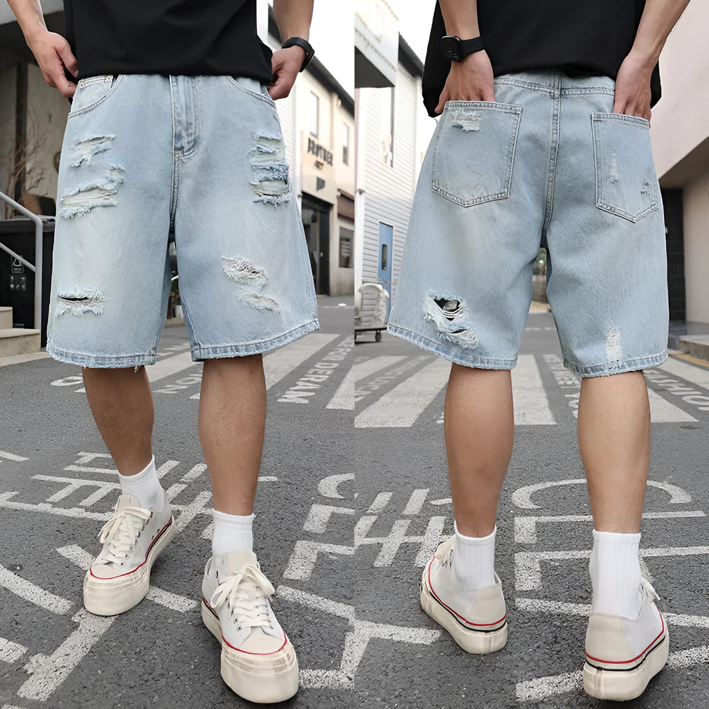 Light blue ripped denim shorts with distressed detailing and loose straight cut fit