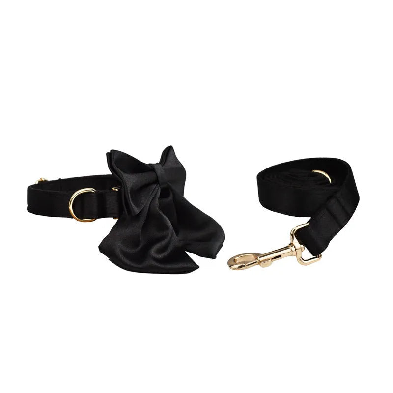 Cloth dog collar and leash set with matching decorative bow and dog vest on a size chart showing S, M, L, XL.