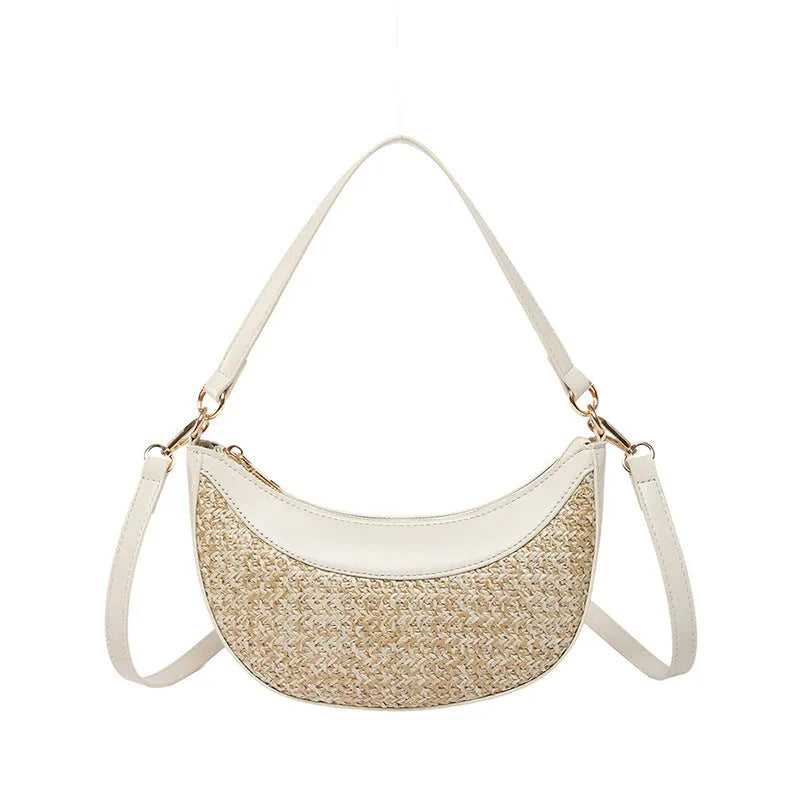 Hard woven straw dumpling-shaped crossbody shoulder bag with organised interior compartments.
