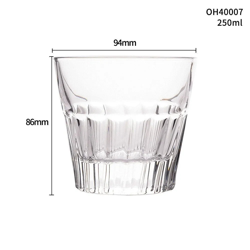 Clear thick-bottom whiskey shot glass with 301-400ml capacity on a table.