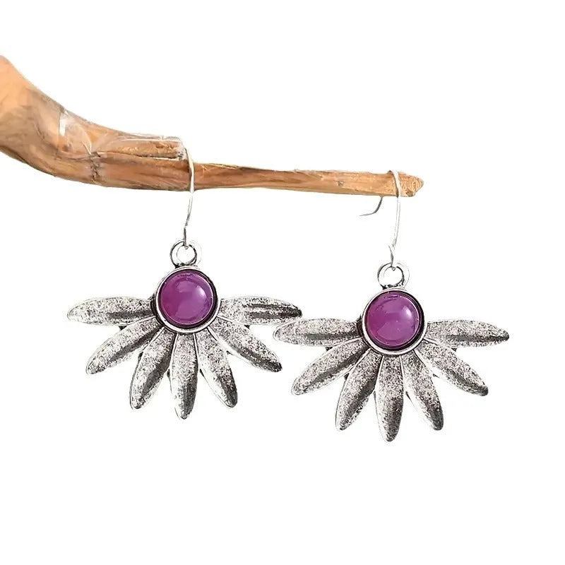 Purple bohemian style earrings with resin gemstone accents and animal zodiac modelling