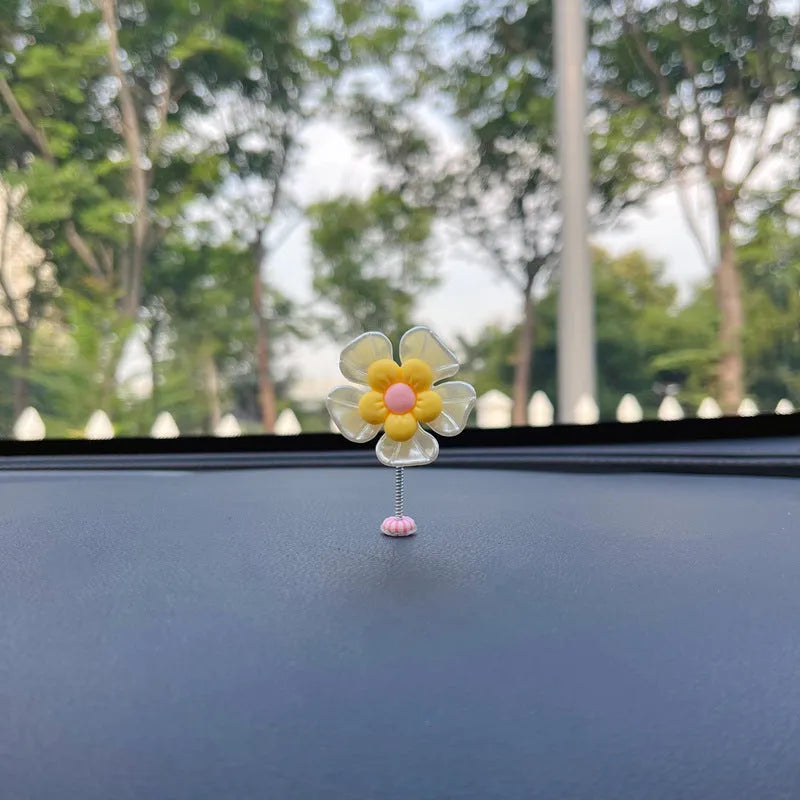 Small colourful plastic swing car decoration ornament in blue, green, pink, purple, or yellow.
