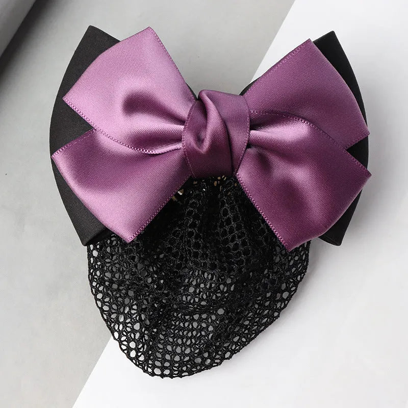 Professional hair clip with a black net pocket and a red flower bow ornament on a white background.