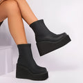 Black plus size women's ankle boots with a wedge heel and round toe on a waterproof platform sole.