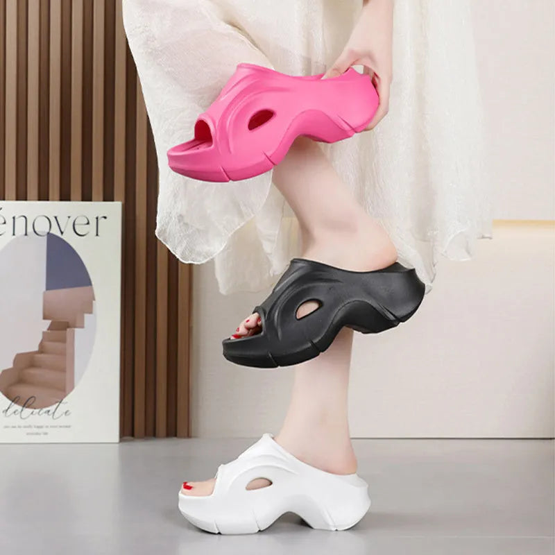 Women's white EVA slippers with thick sole and round toe on a beach background