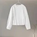 Women's apricot polar fleece suit set with long sleeve top and wide leg trousers on a hanger.