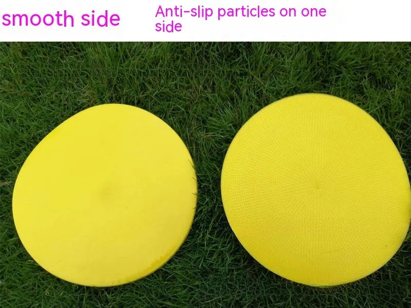 Yellow TPE football training target disc on grass, 23cm diameter flat landmark pad