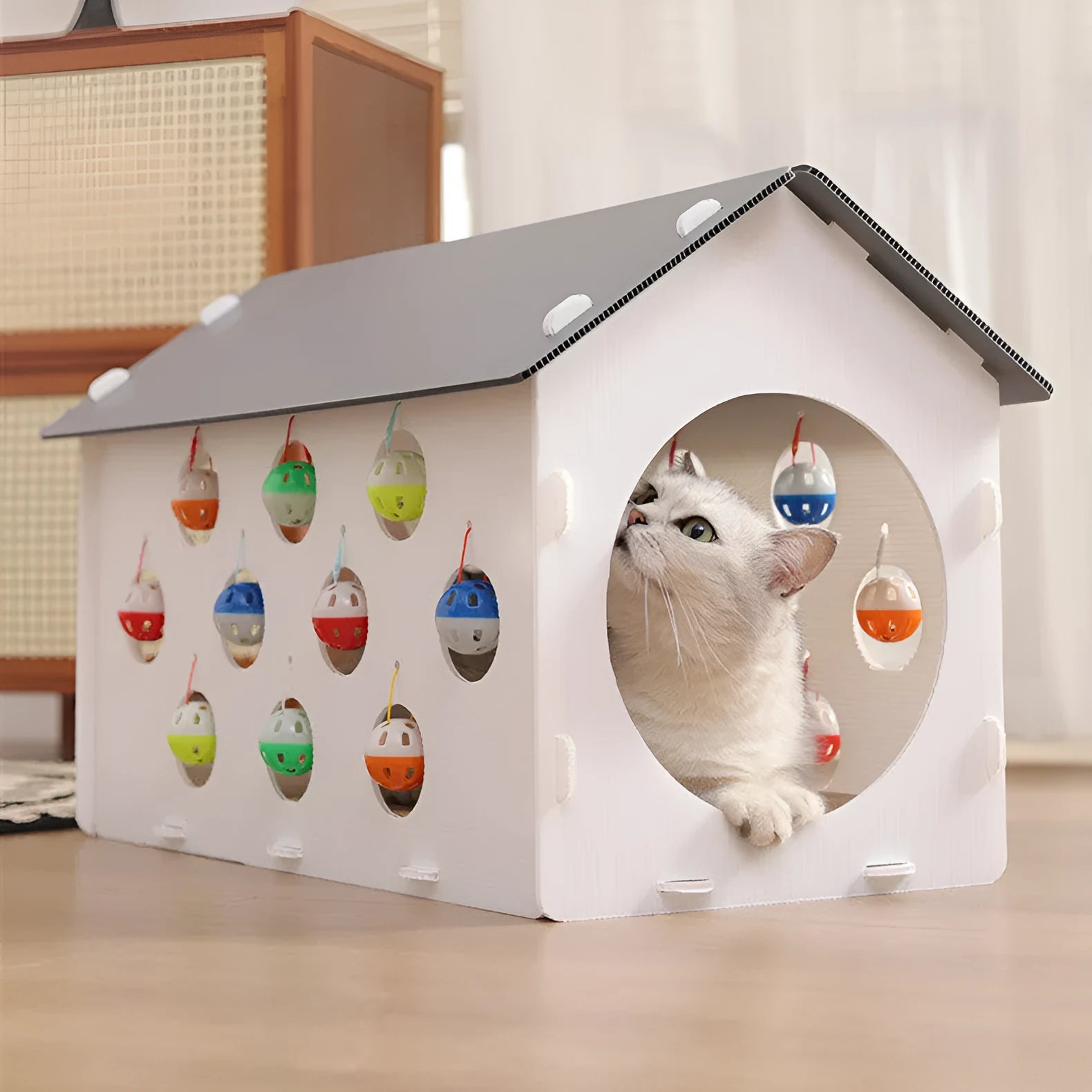 Plastic cat scratch board toy with integrated raised cat nest, tunnel, and bell ball.