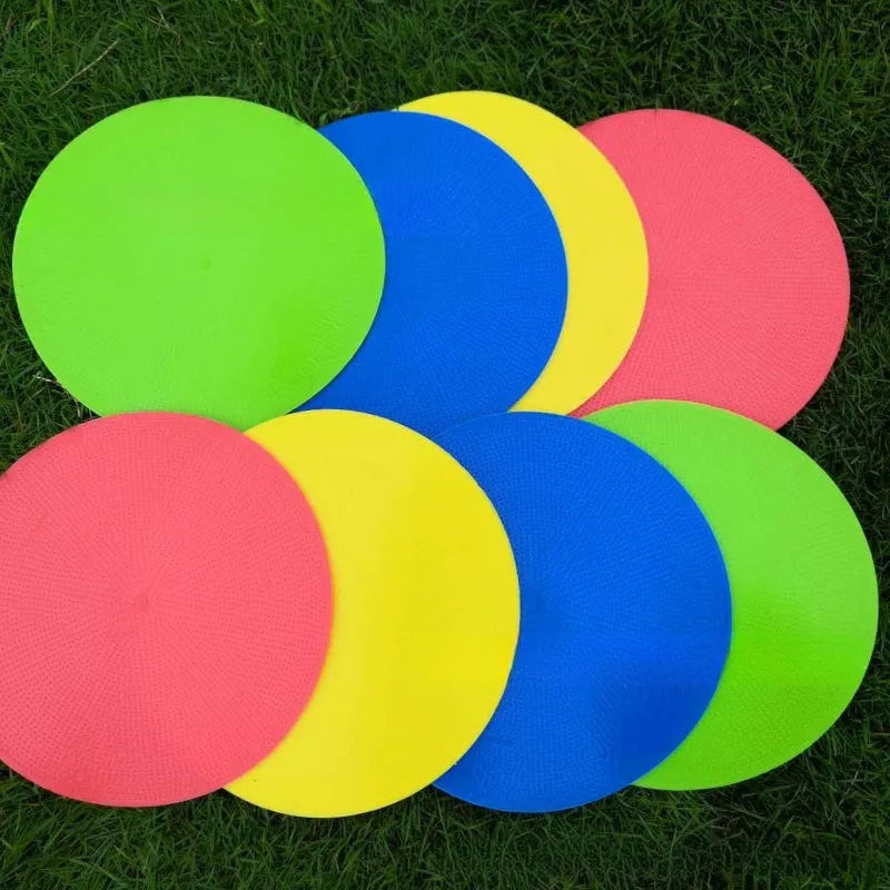 Yellow TPE football training target disc on grass, 23cm diameter flat landmark pad