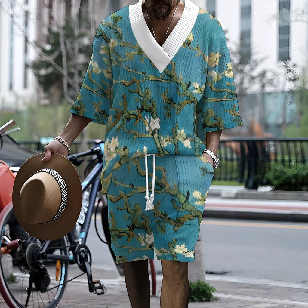 Men's peacock blue 3D printed knitted shorts and T-shirt casual suit set laid flat.