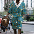 Men's peacock blue 3D printed knitted shorts and T-shirt casual suit set laid flat.