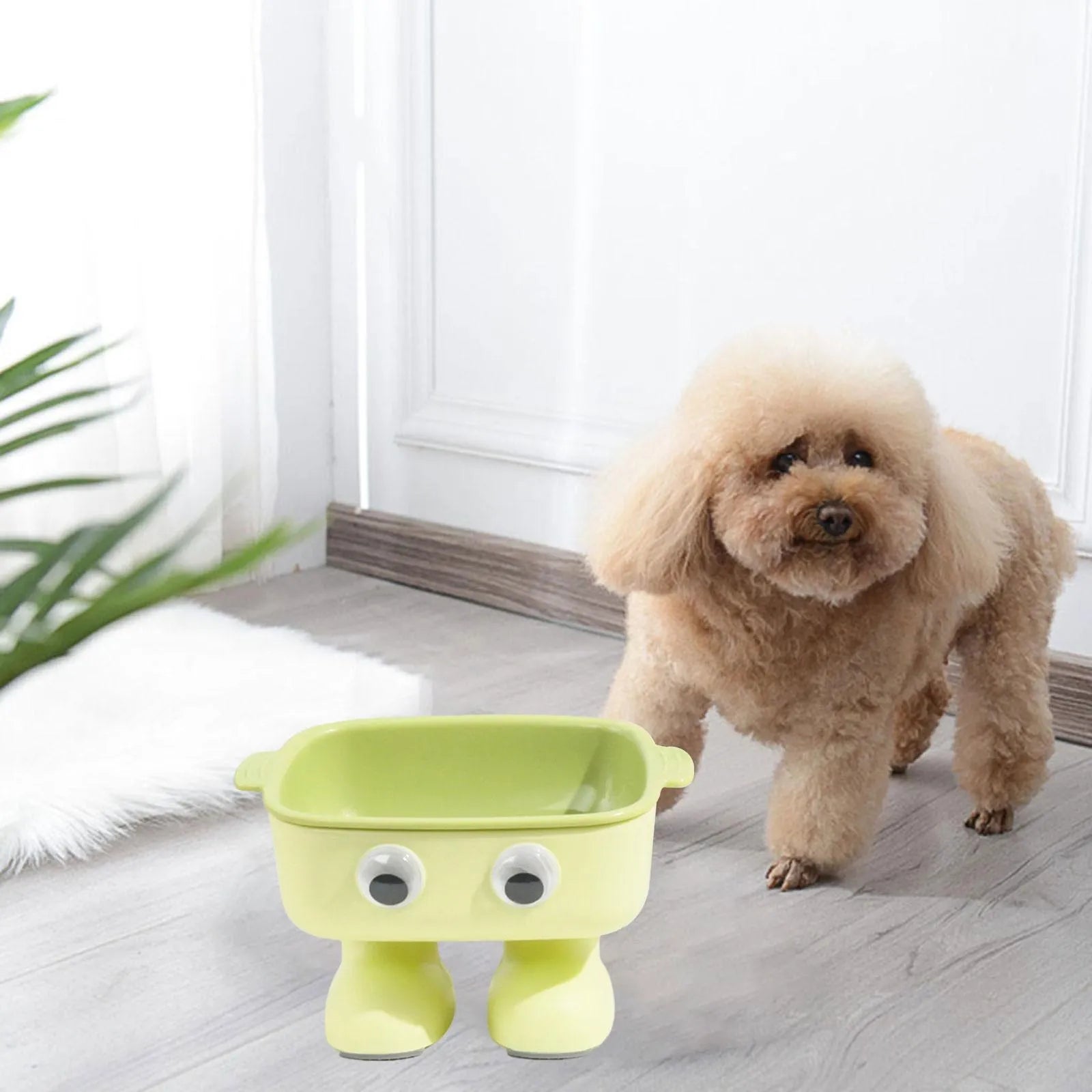 Green robot-shaped elevated cat bowl with tilted dish and anti-slip base.