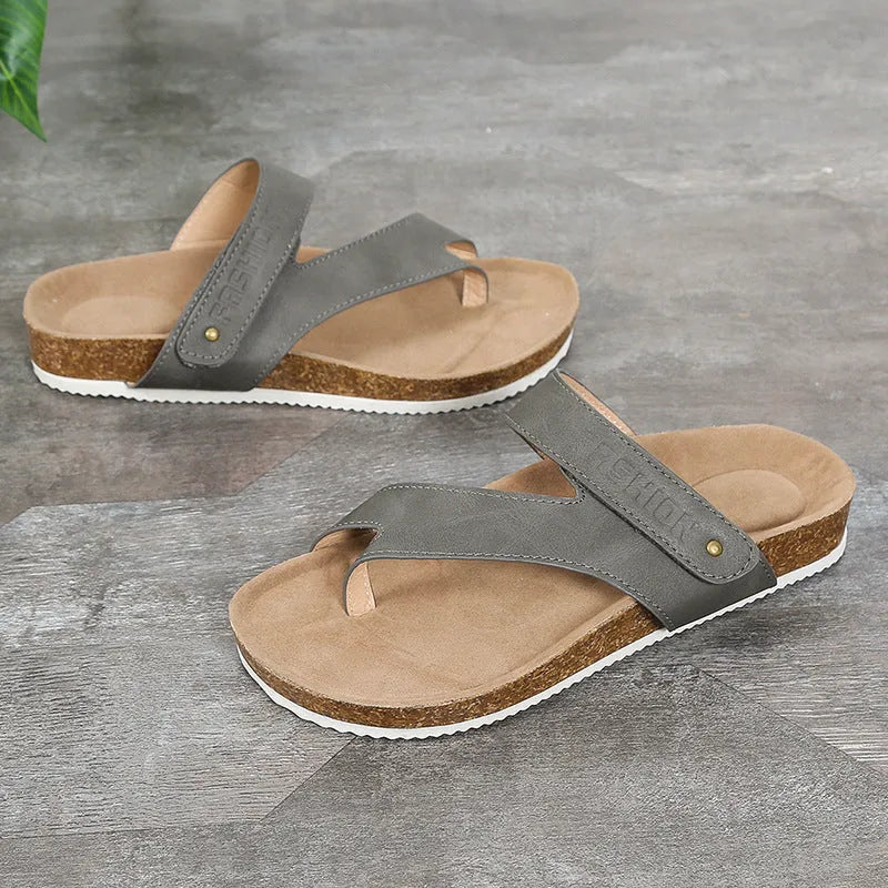 A pair of flat toe ring thick-soled flip-flops in a solid colour on a plain background.