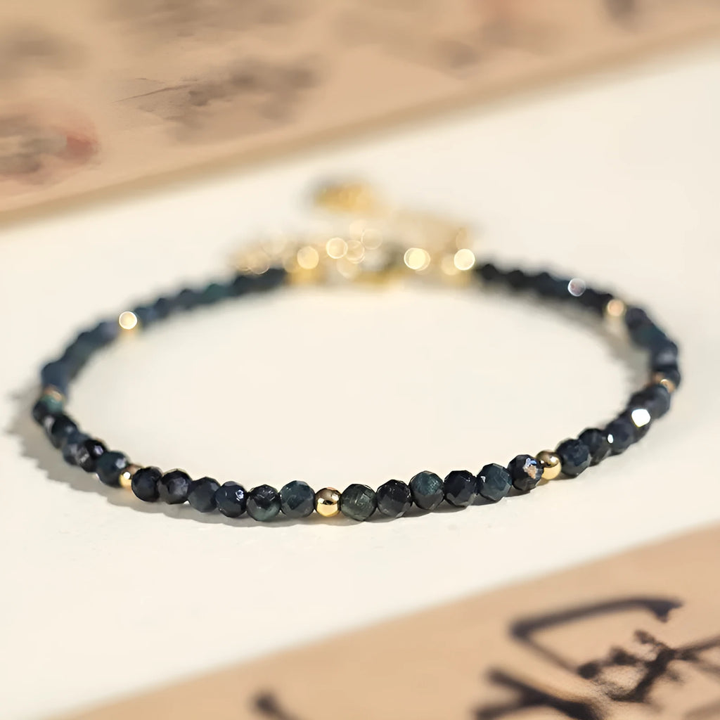 Women's blue tourmaline bracelet with 3mm beads and gold spacer beads